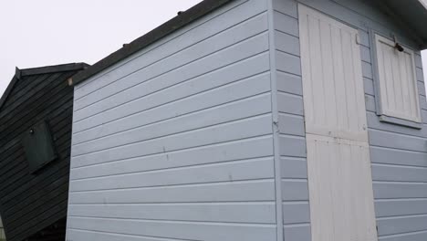 Line-of-beach-huts-lifted-off-their-footings-and-floated-into-grass-car-park