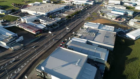 Aerial-drone-shot-of-a-busy-commercial-suburb,-a-new-urban-development-and-trade-hub-for-businesses-in-the-automotive,-industrial-and-distribution-sectors-allowing-for-economic-growth