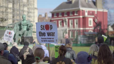 Rally-of-people-gathered-in-York-listening-to-a-speaker-while-holding-posters-that-say-stop-the-war,-in-support-to-Ukraine