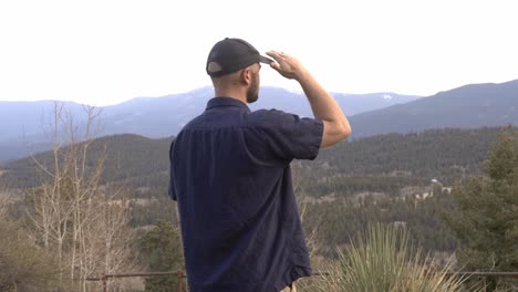 Man-looking-out-over-national-forest-and-the-Lost-Creek-Wilderness-area-near-Bailey,-Colorado