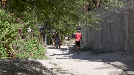 Woman-walking-down-dirt-road