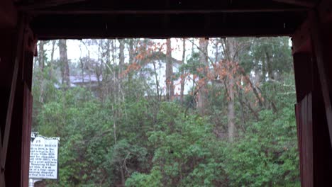 Interior-of-a-covered-bridge-shot-tilts-from-the-roof-to-the-entrance