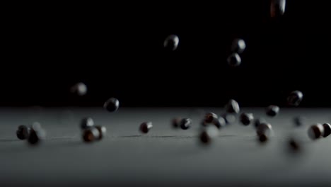 Juniper-grains-fall-on-the-table-in-slow-motion