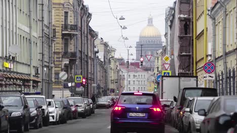 Driving-On-The-Street-In-Saint-Petersburg,-Russia-With-Cars-Parked-On-Both-Side-And-The-St