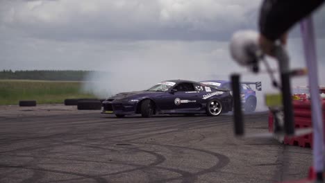 Purple-Toyota-Supra-drifting-against-Toyota-GT86-in-super-slow-motion-in-a-close-race-where-the-Supra-hits-the-wall-and-dirt-flies-in-the-air