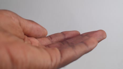 close-up-of-placing-medication-into-African-American-hand-out-of-a-prescription-bottle