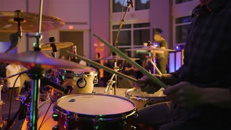 Drumsticks-Striking-Cymbals-On-Rock-Band-Performance-At-Christmas-Eve-Gala-Gig