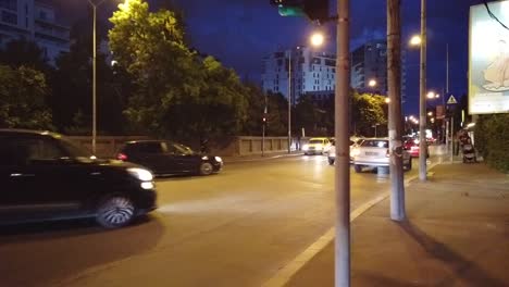 Walking-on-Bucharest-streets-at-night-near-the-road-with-cars-with-a-storm-coming