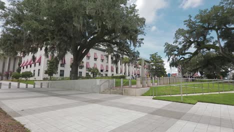 Wide-angle-view-of-the-sign-of-the-Florida-State-Capitol-panning-towards-its-building