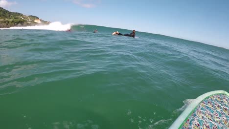 Slow-motion-POV-surfing-Mundaka-Left-hand-Point-Break-on-a-river-mouth-a-surfer-in-action-riding-a-barrel-moving-past