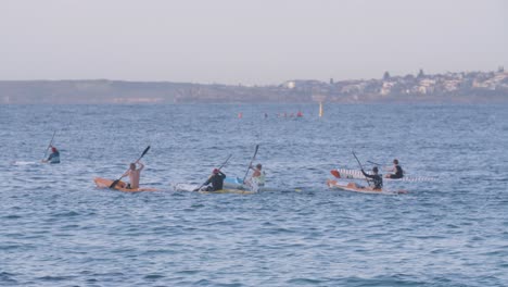 Kayaking-Team-Racing-in-the-Ocean-at-North-Bondi-Bay,-Australia