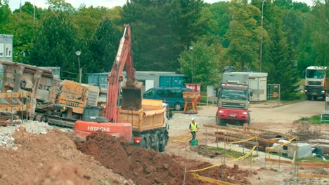 View-of-heavy-machinery-working-on-a-construction-site-loading-the-soil-to-dump-truck