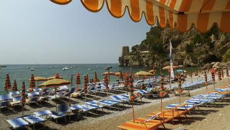 Una-Hermosa-Escena-De-Playa-Italiana-Con-Coloridas-Sombrillas-Y-El-Océano-Azul