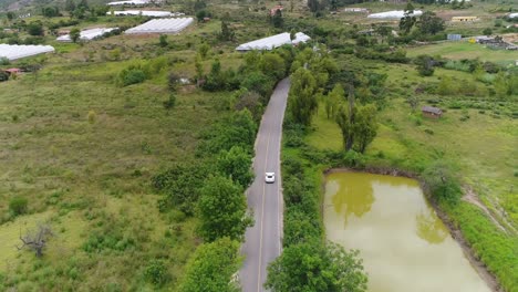 Toma-Aérea-De-Un-Porsche-Cayman-En-Movimiento-En-Las-Carreteras-Colombianas-Durante-Una-Tarde-Soleada-Y-Luminosa.