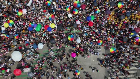 Aerial-view-above-crowded-streets-of-Mexico-city,-during-the-Gay-Pride-Parade---birds-eye,-drone-shot