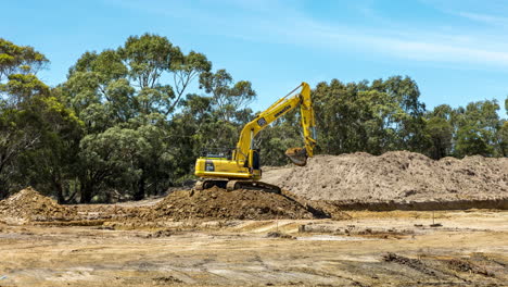 Time-lapse-of-an-excavator-filling-a-dump-truck-with-soil-at-a-housing-development-site