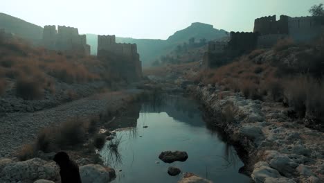 Drone-flight-at-ranikot-fort-in-sindh-pakistan-over-river-near-historical-ruins