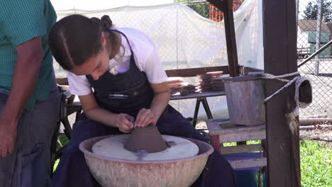 Kutztown,-Pennsylvania---July-1,-2019:-A-girl-making-pottery-at-the-Kutztown-Fair-in-Kutztown,-Pennsylvania-on-July-1,-2019