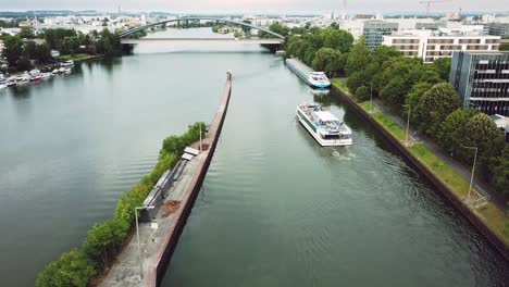 following-and-pasing-by-a-boat-on-the-sewer-of-Frankfurt-am-Main,-Germany