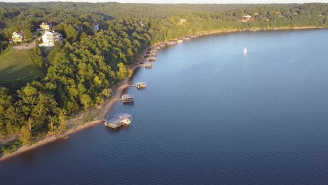 Aerial-view-of-boat-houses-all-in-a-row-on-lake