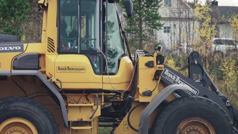 A-blonde-female-bulldozer-operator-working-on-the-road-maintenance