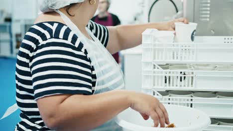Close-up-ladies-working-in-factory-to-create-gelato-ice-cream-food