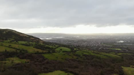 Drone-panning-right-with-fields-and-farmland-and-city-in-the-background