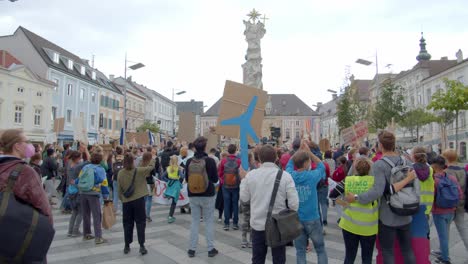 Protesters-Jumping-While-Holding-Placards-At-The-Town-Square