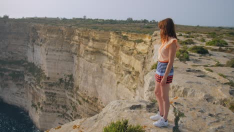Young-Caucasian-Girl-Looking-Enjoying-the-View-at-Ta'-Ċenċ-Cliffs,-Gozo,-Malta