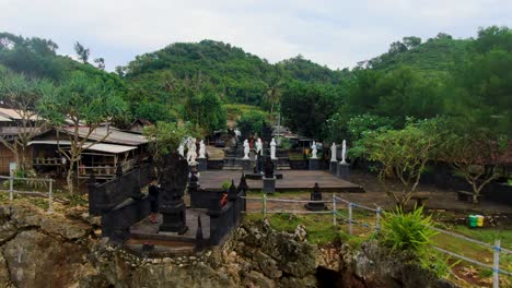 Aerial-view-of-Java-coast-and-Hindu-Temple-on-cliff-by-Ngobaran-beach,-Indonesia