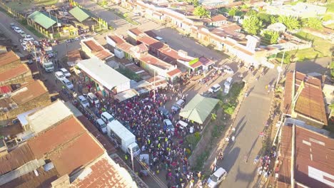 Politician-Campaigning-With-A-Huge-Cloud-Of-People-Kenya-Aerial-Drone-Wide-Shot