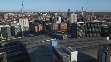 Aerial-Drone-Shot-of-Leeds-City-Centre-Looking-Over-Leeds-Train-Station-on-an-Autumn-Morning-in-West-Yorkshire,-UK