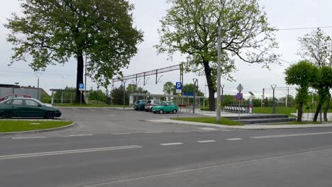 Olesno-Slaskie-main-train-station-view-during-building-renewal-with-parking-cars-at-cloudy-weather