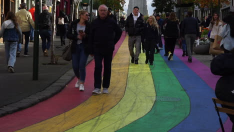 People-walking-on-Rainbow-Road-in-Reykjavik,-Iceland