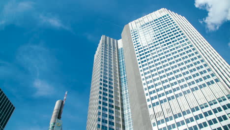 EuroTower-in-Frankfurt-with-Commerz-Bank-skyscraper,-bright-blue-sky