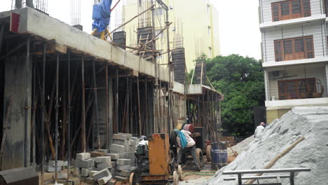 A-team-of-construction-workers-in-India-mixing-concrete-to-make-the-roof-of-a-new-house