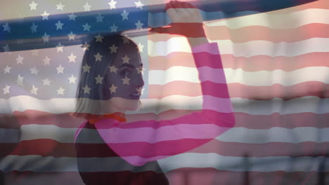 Animation-of-flag-of-usa-over-caucasian-woman-holding-surfboard