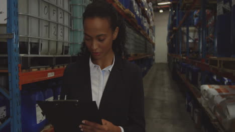 Animation-of-data-processing-over-african-american-female-worker-in-warehouse