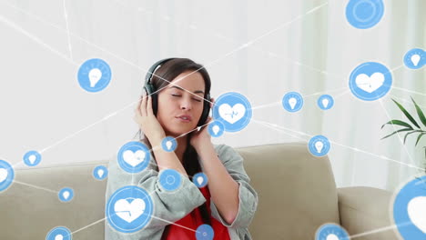 Animation-of-network-of-connections-with-icons-over-caucasian-woman-using-headphones