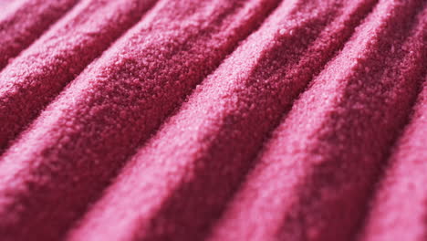 Close-up-of-a-textured-pink-fabric-with-a-ribbed-pattern