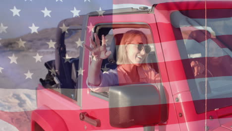 Animation-of-flag-of-usa-over-happy-caucasian-woman-driving-car-on-beach
