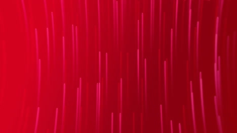 Animation-of-glowing-light-trails-moving-on-red-background