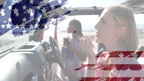 Animation-of-flag-of-usa-over-happy-diverse-women-in-car-by-beach-in-summer