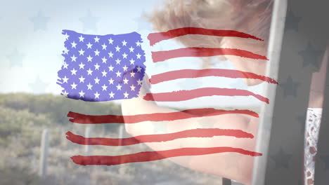 Animation-of-flag-of-usa-over-caucasian-woman-in-car-on-beach