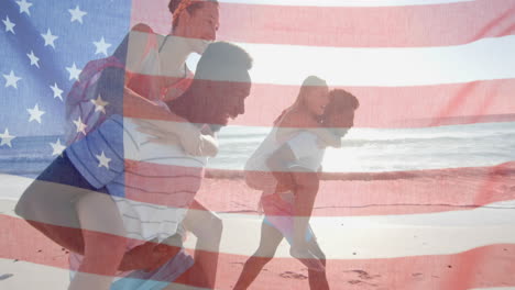 Animation-of-flag-of-usa-over-happy-diverse-men-carrying-women-piggyback-on-beach-in-summer