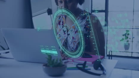 Animation-of-circular-scanner-and-data-over-african-american-businesswoman-using-laptop-at-office