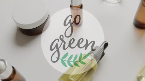 Animation-of-go-green-text-and-leaf-logo-over-natural-beauty-creams-and-oils-on-white