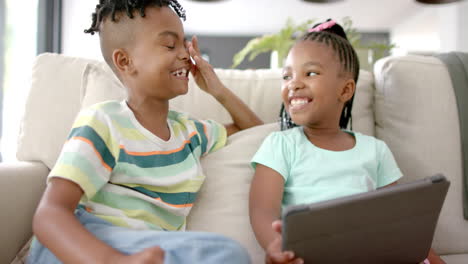 Hermano-Y-Hermana-Afroamericanos-Comparten-Un-Momento-Alegre-Con-Una-Tableta-En-Casa