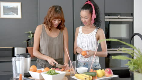 Two-biracial-female-friends-are-preparing-food-in-a-modern-kitchen