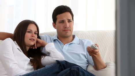 Caucasian-couple-relaxing-on-couch-